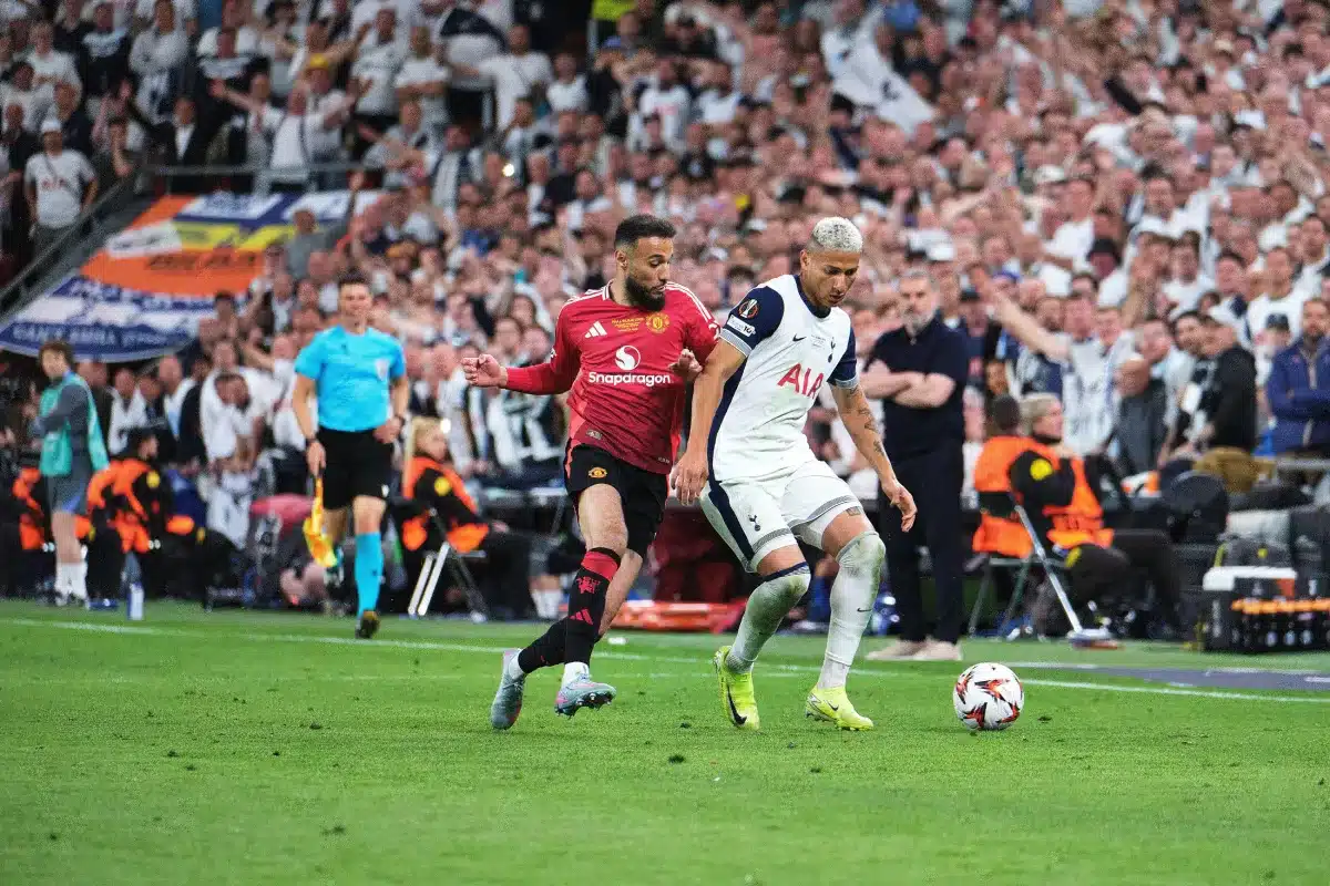 Richarlison of Tottenham Hotspur challenges for the ball with Noussair Mazraoui of Manchester United